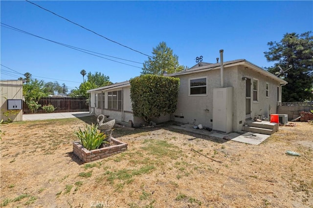 7737 Nestle Ave, Reseda, CA 91335 - back of house with stucco siding and a patio