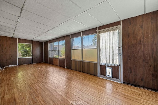 7737 Nestle Ave, Reseda, CA 91335 - spare room with hardwood / wood-style floors and wooden walls