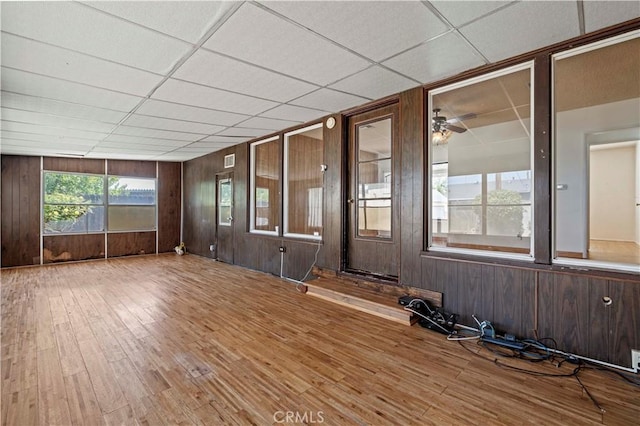 7737 Nestle Ave, Reseda, CA 91335 - spare room featuring wood finished floors, wooden walls, ceiling fan, and a paneled ceiling