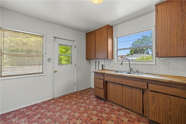 7737 Nestle Ave, Reseda, CA 91335 - kitchen with tasteful backsplash, light countertops, and brown cabinetry