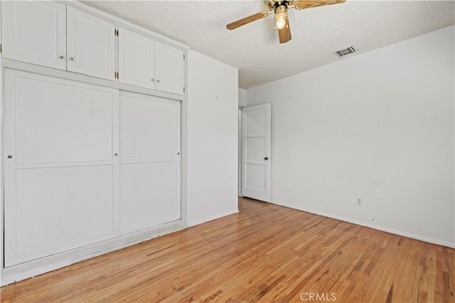 7737 Nestle Ave, Reseda, CA 91335 - unfurnished bedroom with light wood-style flooring, a closet, a textured ceiling, and ceiling fan