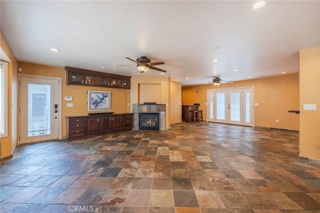 805 Ocean Ave Unit 6, Seal Beach, CA 90740 - unfurnished living room with stone tile flooring, a ceiling fan, a tile fireplace, and recessed lighting