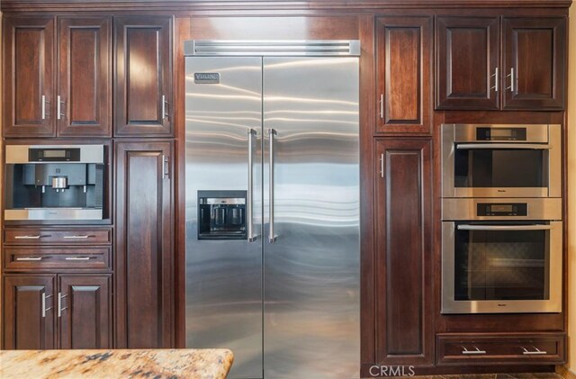 805 Ocean Ave Unit 6, Seal Beach, CA 90740 - kitchen with stainless steel appliances, light stone countertops, and dark brown cabinetry