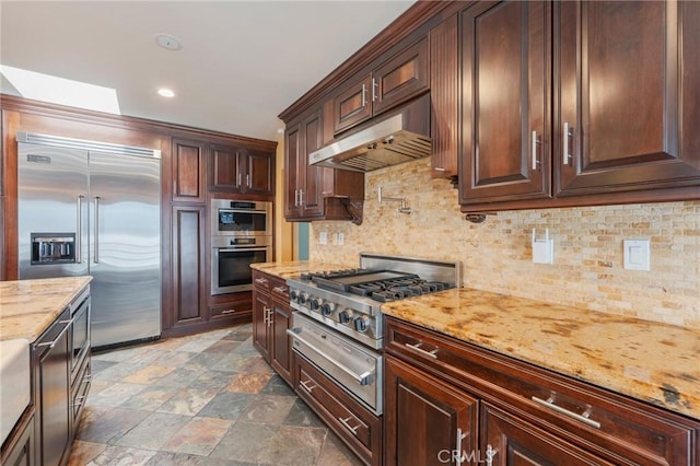 805 Ocean Ave Unit 6, Seal Beach, CA 90740 - kitchen with stainless steel appliances, under cabinet range hood, tasteful backsplash, light stone countertops, and recessed lighting