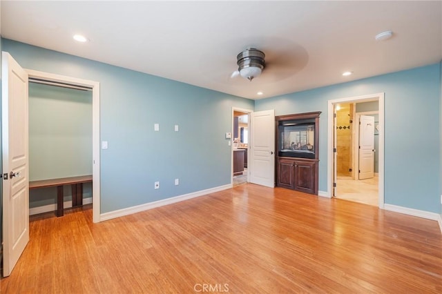 805 Ocean Ave Unit 6, Seal Beach, CA 90740 - unfurnished bedroom featuring light wood-style flooring, recessed lighting, a spacious closet, ensuite bath, and ceiling fan