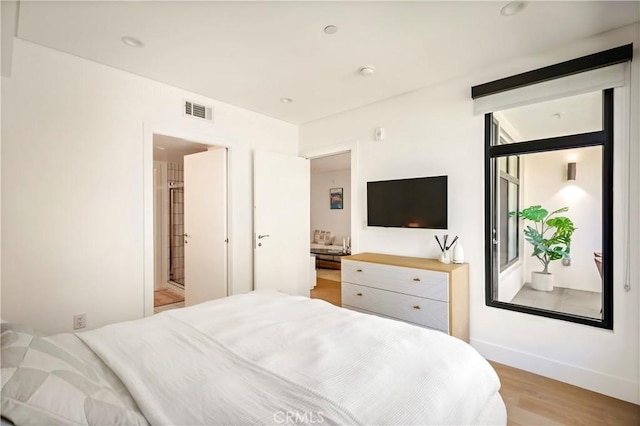 399 E Del Mar Blvd Unit 110, Pasadena, CA 91101 - bedroom featuring light wood-type flooring and connected bathroom