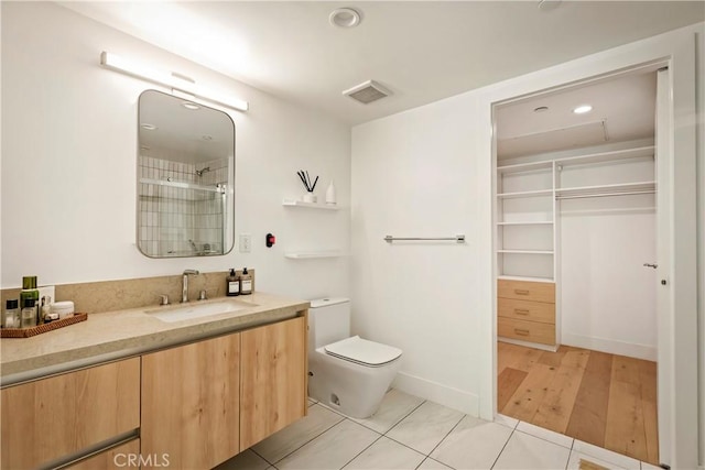 399 E Del Mar Blvd Unit 110, Pasadena, CA 91101 - bathroom with vanity, a shower, a spacious closet, recessed lighting, and tile patterned floors