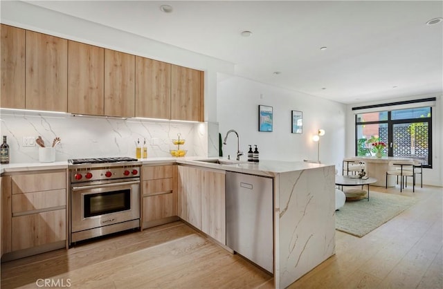 399 E Del Mar Blvd Unit 110, Pasadena, CA 91101 - kitchen featuring appliances with stainless steel finishes, light brown cabinets, modern cabinets, and light wood-style flooring