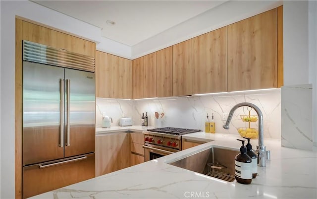 399 E Del Mar Blvd Unit 110, Pasadena, CA 91101 - kitchen featuring premium appliances, modern cabinets, and light stone countertops