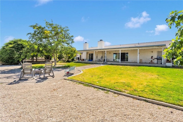 16912 Danbury Ave, Hesperia, CA 92345 - back of house with a yard, a patio, and a chimney
