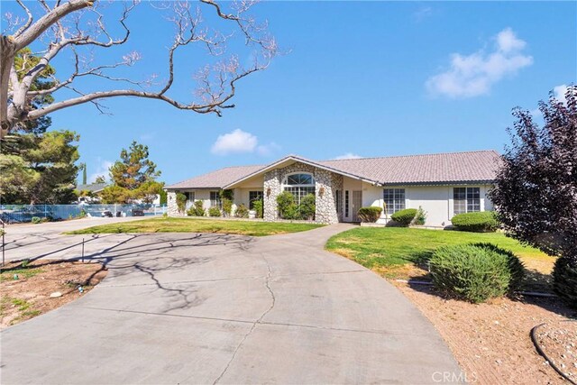 16912 Danbury Ave, Hesperia, CA 92345 - ranch-style house featuring a front lawn, curved driveway, stucco siding, and stone siding