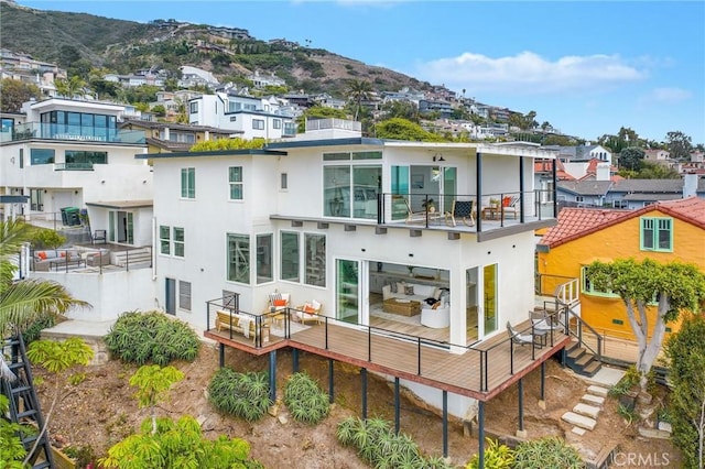 32015 Point Pl, Laguna Beach, CA 92651 - rear view of property featuring stucco siding, a residential view, a deck with mountain view, and a balcony