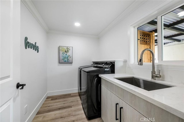 32015 Point Pl, Laguna Beach, CA 92651 - laundry room featuring washing machine and dryer, cabinet space, crown molding, and light wood-style flooring
