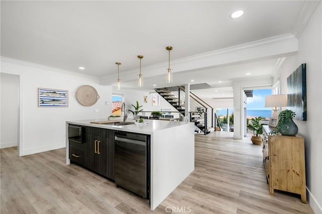 32015 Point Pl, Laguna Beach, CA 92651 - kitchen featuring dishwasher, an island with sink, crown molding, light countertops, and light wood-type flooring