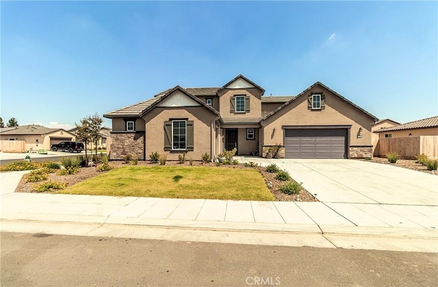 2698 N Arroyo Ave, Fresno, CA 93727 - traditional home with driveway, stucco siding, and stone siding