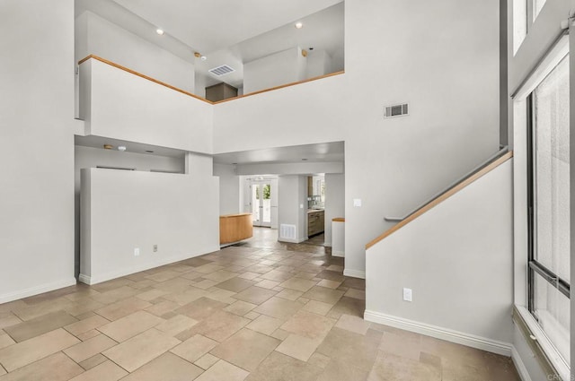 3112 N Mountain View Dr, San Diego, CA 92116 - unfurnished living room featuring a high ceiling, stone tile floors, and stairway