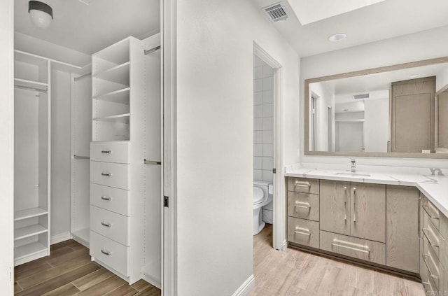 3112 N Mountain View Dr, San Diego, CA 92116 - bathroom with vanity, wood finished floors, and a closet