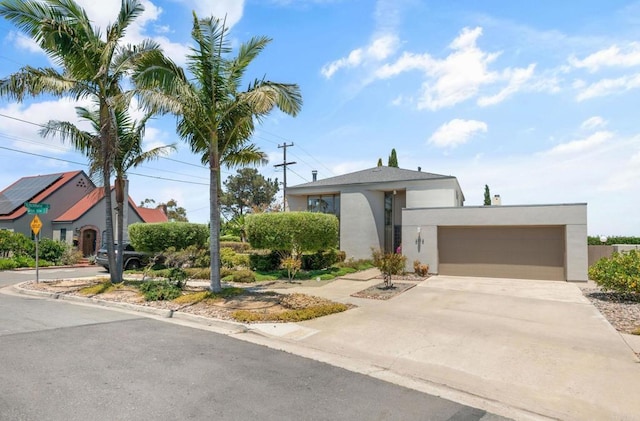 3112 N Mountain View Dr, San Diego, CA 92116 - view of front of house with stucco siding, driveway, and a garage