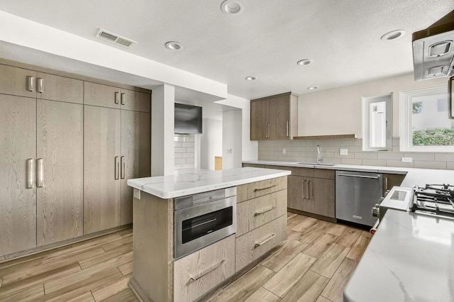 3112 N Mountain View Dr, San Diego, CA 92116 - kitchen featuring stainless steel appliances, wood finish floors, backsplash, light stone countertops, and recessed lighting