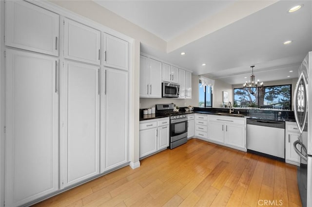 220 S Prospect Ave Unit 9, Redondo Beach, CA 90277 - kitchen featuring stainless steel appliances, dark countertops, white cabinetry, a chandelier, and recessed lighting