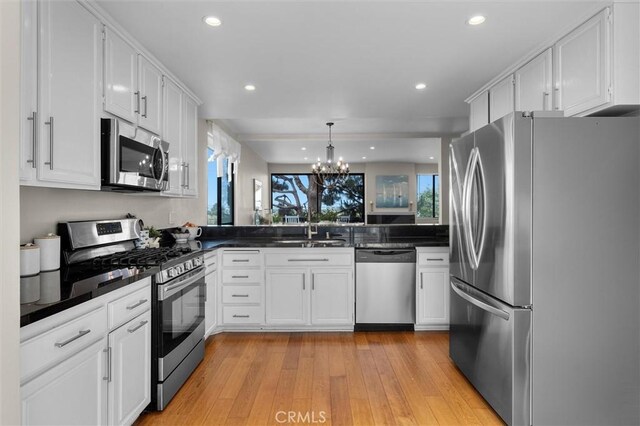 220 S Prospect Ave Unit 9, Redondo Beach, CA 90277 - kitchen featuring stainless steel appliances, dark countertops, a chandelier, white cabinets, and recessed lighting