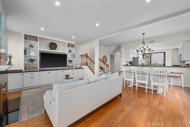 220 S Prospect Ave Unit 9, Redondo Beach, CA 90277 - living area featuring a chandelier, stairs, light wood finished floors, and recessed lighting