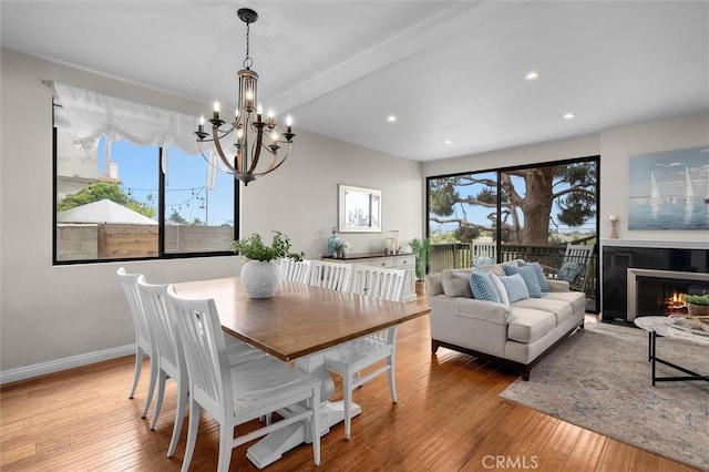 220 S Prospect Ave Unit 9, Redondo Beach, CA 90277 - dining space with a chandelier, wood finished floors, recessed lighting, a lit fireplace, and beam ceiling