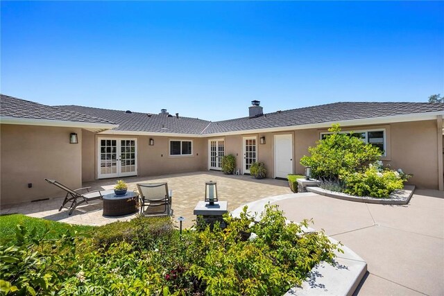 1831 Cockscrow Ln, North Tustin, CA 92705 - back of house featuring french doors, a patio area, stucco siding, and a chimney