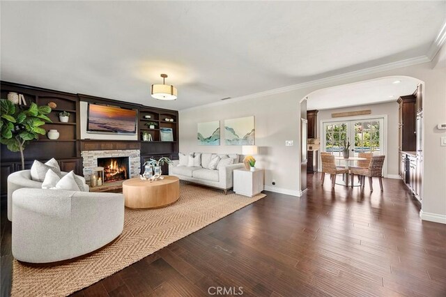 1831 Cockscrow Ln, North Tustin, CA 92705 - living area featuring arched walkways, ornamental molding, dark wood-style flooring, and a stone fireplace