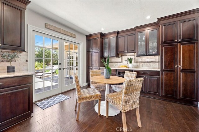 1831 Cockscrow Ln, North Tustin, CA 92705 - kitchen with french doors, dark brown cabinetry, glass insert cabinets, decorative backsplash, and recessed lighting