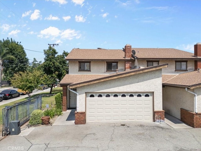 406 Genoa St Unit A, Monrovia, CA 91016 - view of front of home featuring stucco siding, asphalt driveway, a chimney, an attached garage, and roof with shingles
