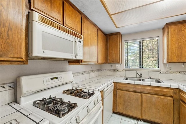 406 Genoa St Unit A, Monrovia, CA 91016 - kitchen with white appliances, brown cabinets, tile counters, and light tile patterned floors