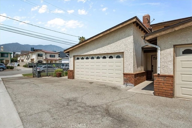 406 Genoa St Unit A, Monrovia, CA 91016 - view of property exterior featuring a mountain view, stucco siding, brick siding, a chimney, and a residential view