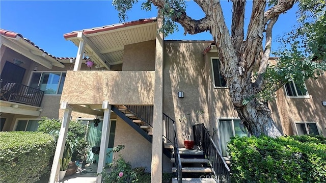 13722 Red Hill Ave Unit 20, Tustin, CA 92780 - view of side of home with stucco siding and stairs