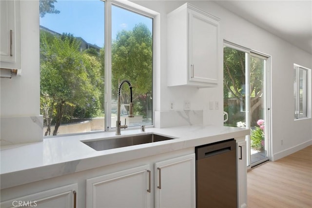 7 Gatewood Dr, Aliso Viejo, CA 92656 - kitchen featuring stainless steel dishwasher, white cabinetry, light wood-style floors, and light countertops