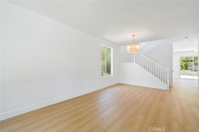 7 Gatewood Dr, Aliso Viejo, CA 92656 - spare room with a chandelier, light wood-style floors, and stairs
