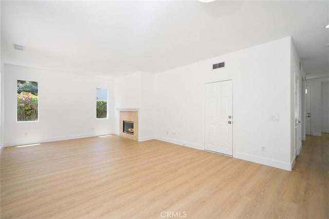 7 Gatewood Dr, Aliso Viejo, CA 92656 - unfurnished living room with light wood finished floors, plenty of natural light, and a glass covered fireplace
