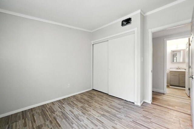10150 Sierra Madre Rd, Spring Valley, CA 91977 - unfurnished bedroom featuring light wood-type flooring, ornamental molding, and a closet