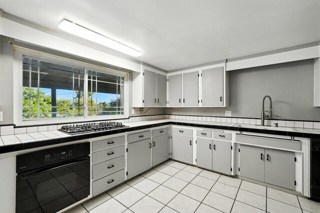 10150 Sierra Madre Rd, Spring Valley, CA 91977 - kitchen with stainless steel gas cooktop, oven, tile counters, light tile patterned flooring, and dishwashing machine