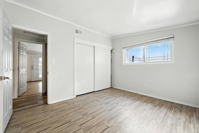 10150 Sierra Madre Rd, Spring Valley, CA 91977 - unfurnished bedroom featuring ornamental molding, wood finished floors, and a closet