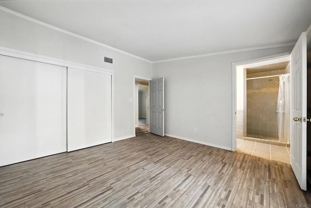 10150 Sierra Madre Rd, Spring Valley, CA 91977 - unfurnished bedroom with ornamental molding, wood finished floors, a closet, and ensuite bathroom