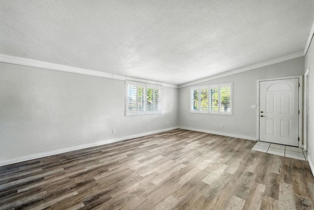 10150 Sierra Madre Rd, Spring Valley, CA 91977 - unfurnished room featuring a textured ceiling, wood finished floors, vaulted ceiling, and crown molding