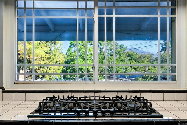10150 Sierra Madre Rd, Spring Valley, CA 91977 - kitchen view of tile countertops, black gas cooktop, and decorative backsplash