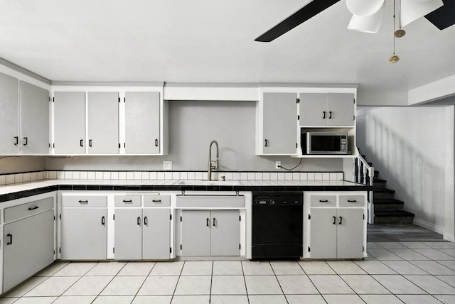 10150 Sierra Madre Rd, Spring Valley, CA 91977 - kitchen with black dishwasher, stainless steel microwave, ceiling fan, tile counters, and light tile patterned floors