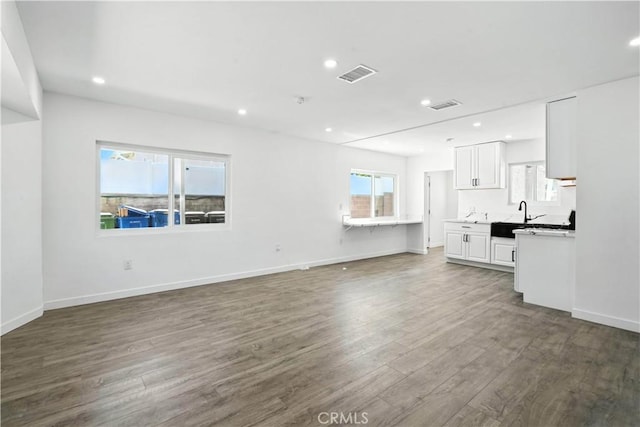 13886 Paxton St, Pacoima, CA 91331 - unfurnished living room featuring wood finished floors and recessed lighting