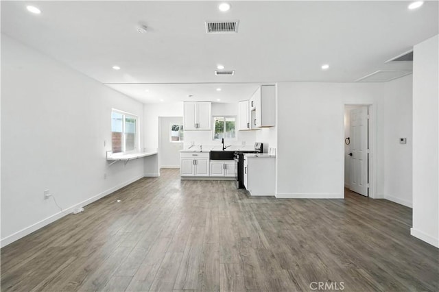 13886 Paxton St, Pacoima, CA 91331 - unfurnished living room featuring wood finished floors, plenty of natural light, and recessed lighting