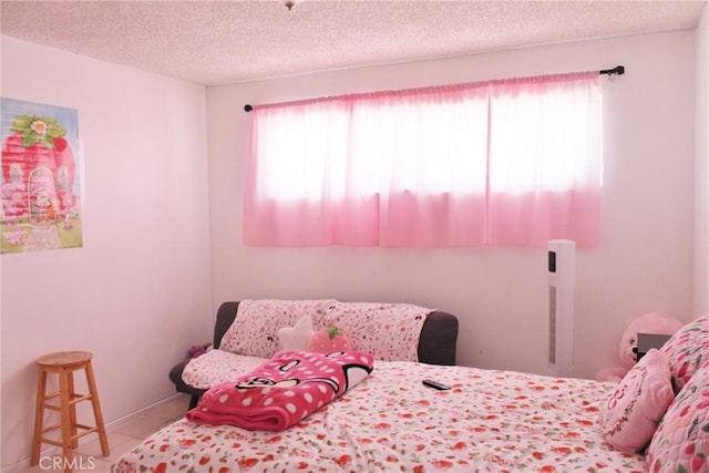 10343 Amherst Ave, Montclair, CA 91763 - bedroom featuring multiple windows, a textured ceiling, and tile patterned flooring