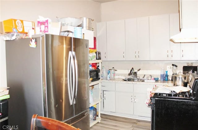 10343 Amherst Ave, Montclair, CA 91763 - kitchen with freestanding refrigerator, gas stove, light countertops, under cabinet range hood, and white cabinets