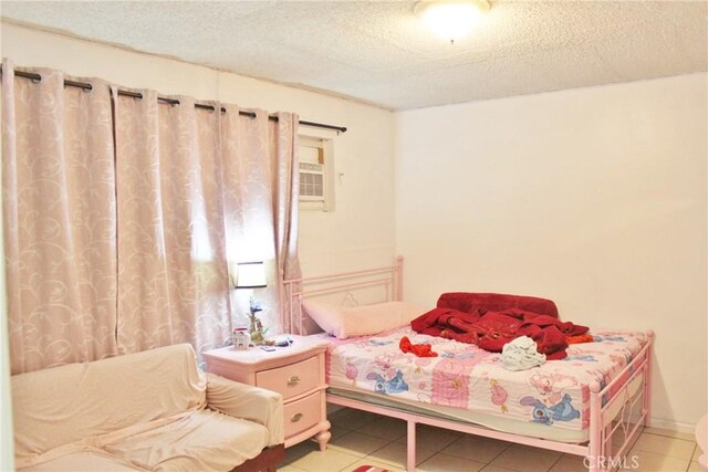 10343 Amherst Ave, Montclair, CA 91763 - bedroom featuring light tile patterned floors, a textured ceiling, and a wall unit AC