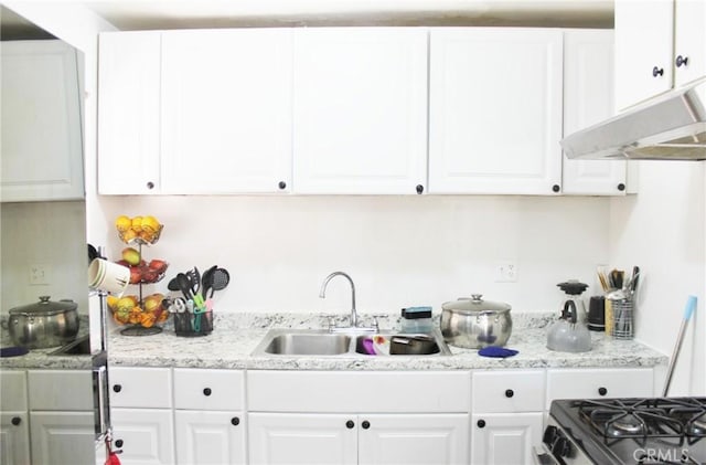 10343 Amherst Ave, Montclair, CA 91763 - kitchen featuring white cabinetry, under cabinet range hood, and light stone counters